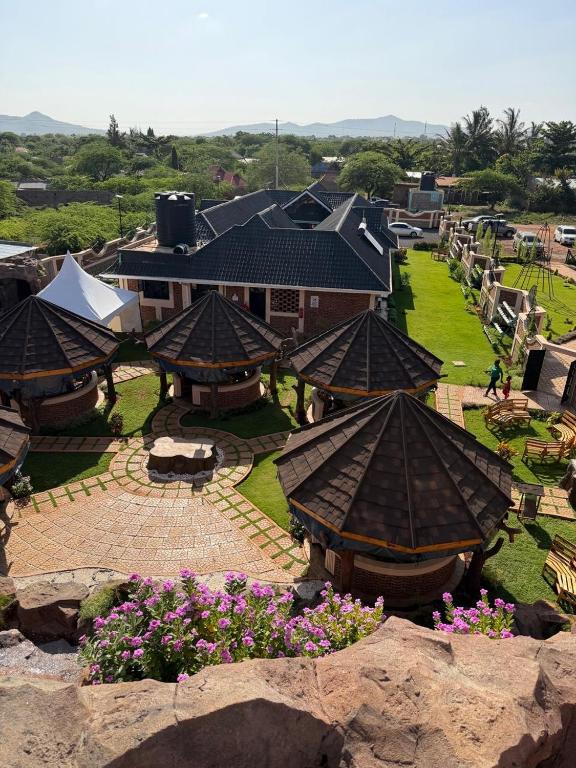an aerial view of a building with roofs and flowers at Mawimbi Jiko Hotel in Taveta