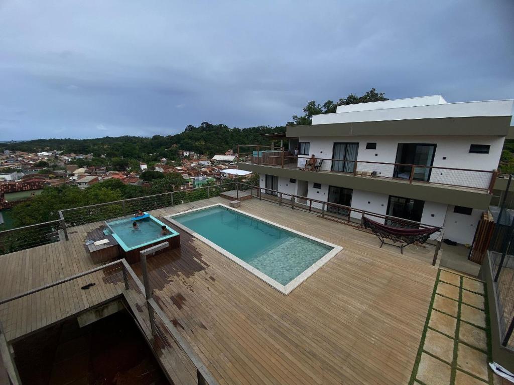 a swimming pool on the deck of a house at Villa Visgo Itacaré in Itacaré