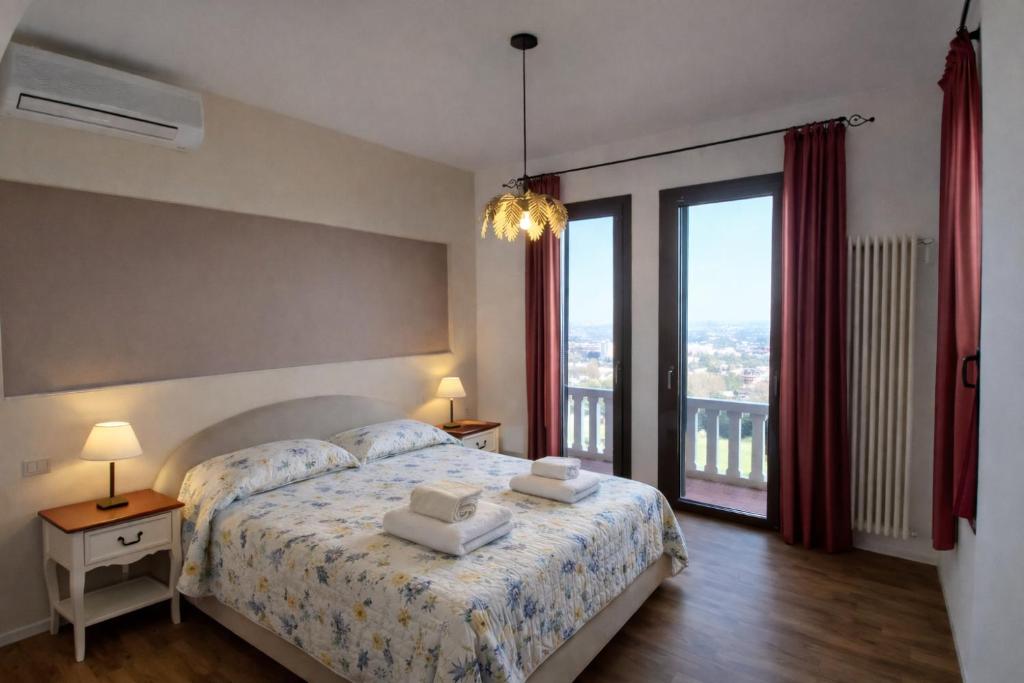 a bedroom with a bed and a large window at Corina's Place Bologna Home in Bologna