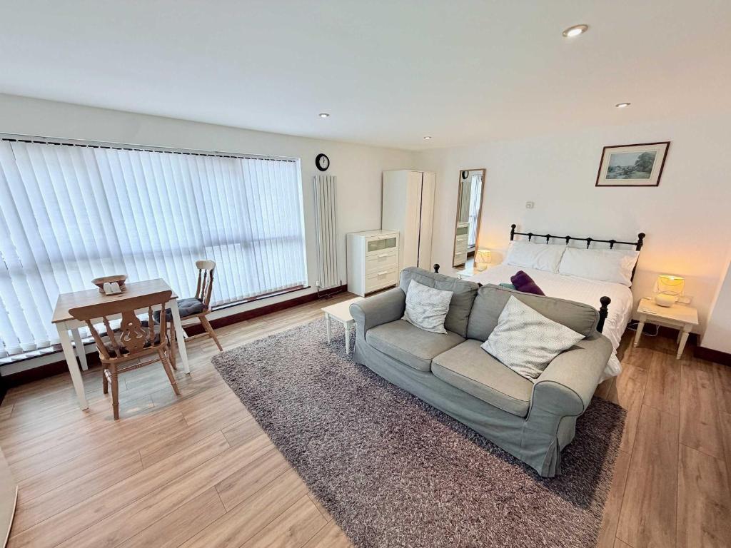 a living room with a couch and a table at Millbrook House Apartments 9 in Milton