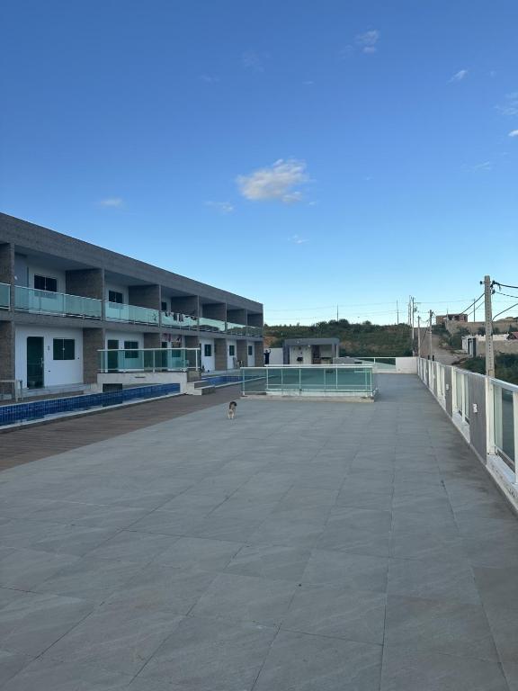 a dog is standing on the roof of a building at Condominio HOME DUPLEX SERRA NEGRA in Bezerros