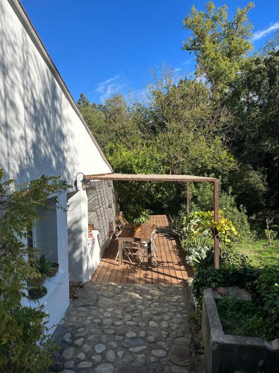 a patio with a table and chairs in a yard at La maison de Juliette in Céret