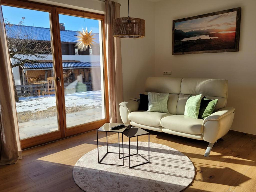 a living room with a couch and a table at Ferienwohnung Obstgarten in Halblech