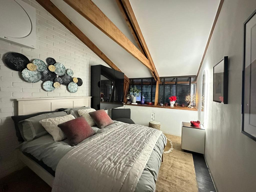 a bedroom with a large bed and a brick wall at Luxury Double Room in Chislehurst