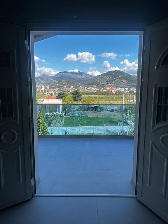 a large window with a view of a city at Modern Getaway Meets Nature in Ishull-Shëngjini