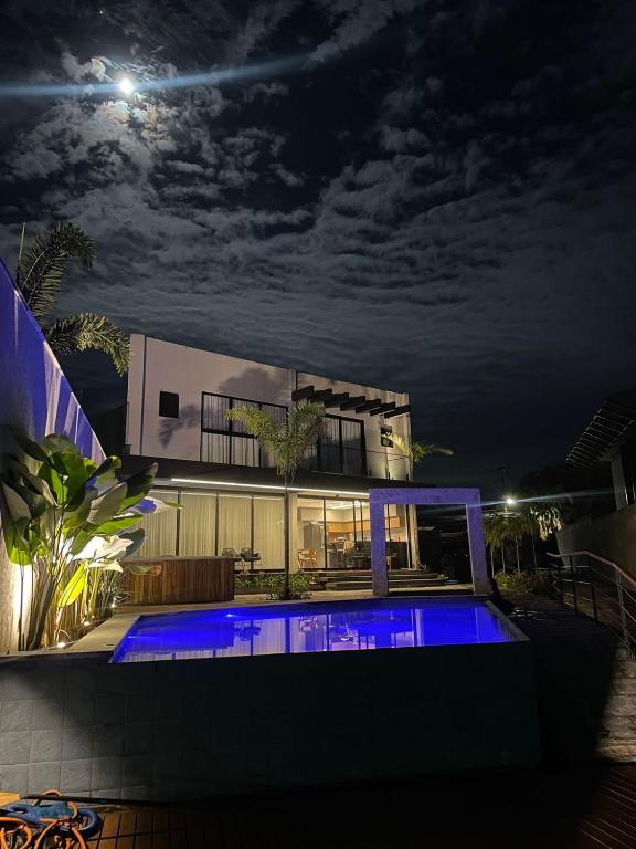 a house with a swimming pool at night at Angra casa in Angra dos Reis