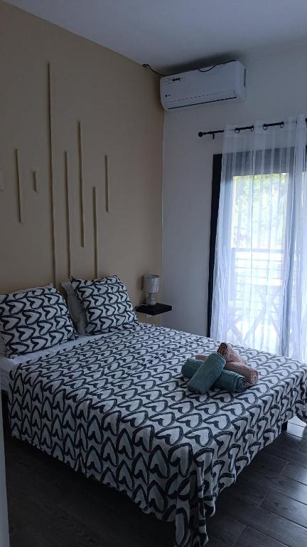 a person laying on a bed in a bedroom at Résidence LE MÄYSA CORAIL in Sada