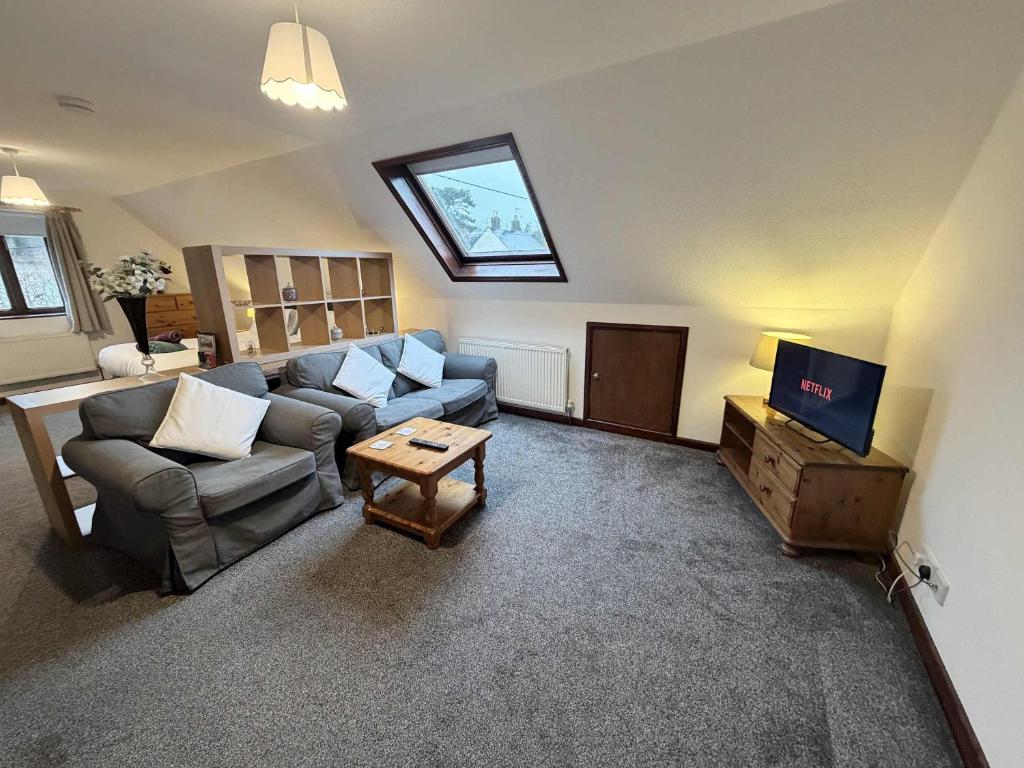 a living room with a couch and a tv at Millbrook House Apartments 2 in Milton