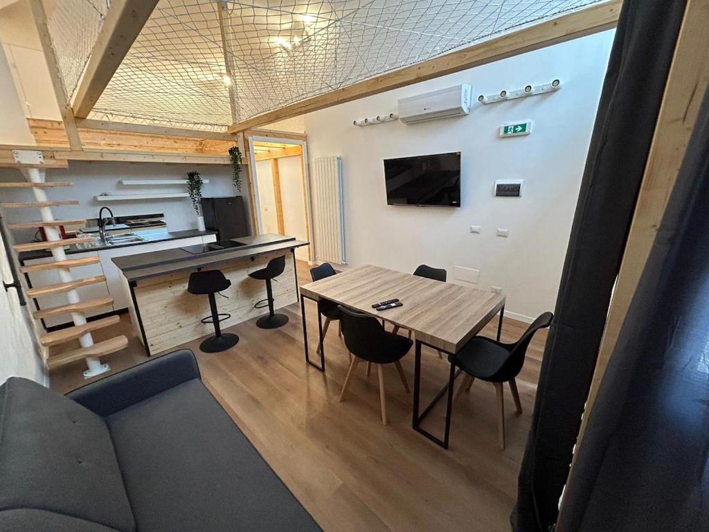 a living room with a wooden table and chairs at Loft bridge in Ascoli Piceno