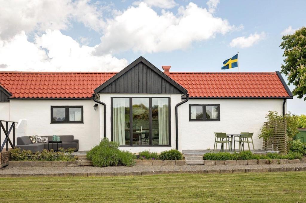 a white house with an orange roof at Stendala Gård in Gärsnäs