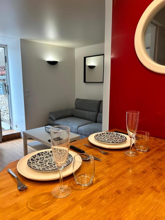 a table with plates and glasses on top of it at studio confort seine port in Seine-Port