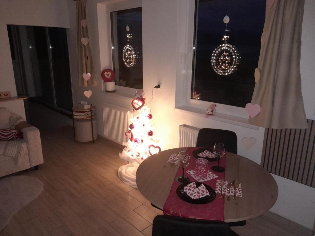 a living room with a table and a christmas tree at Biela Magnólia in Vrbov