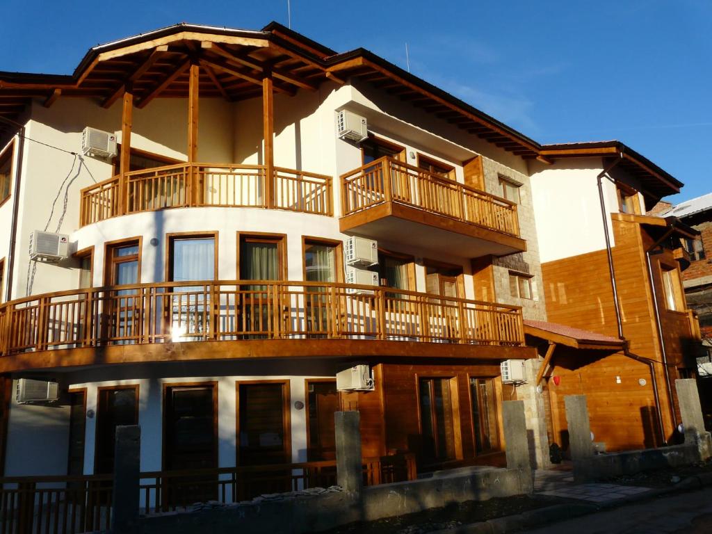 a building with a balcony on top of it at Yuliya Guest House in Sapareva Banya