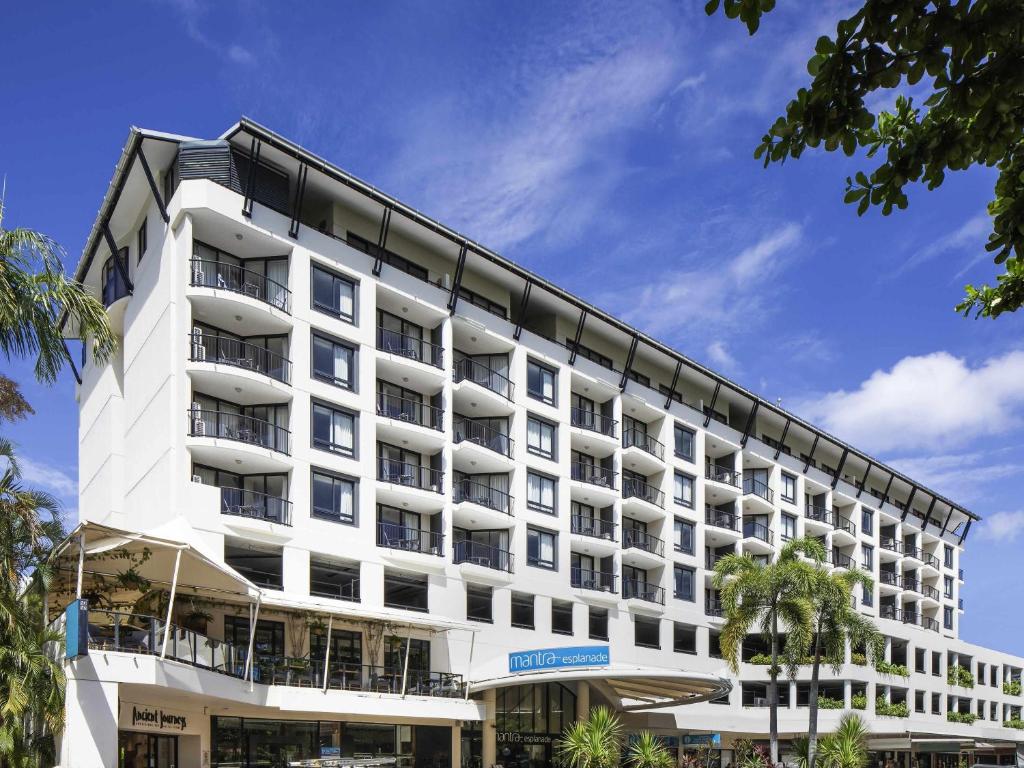 a large white building with balconies on it at Mantra Esplanade in Cairns