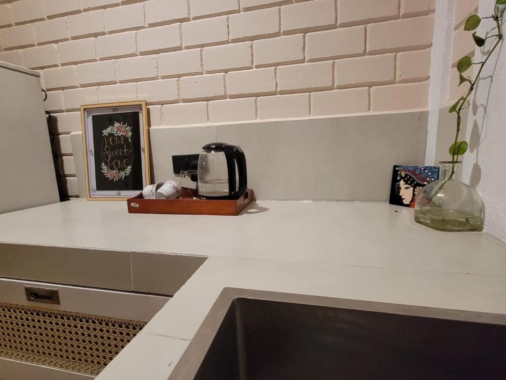 a kitchen counter top with a toaster and a sink at Stay Zen in Arangala