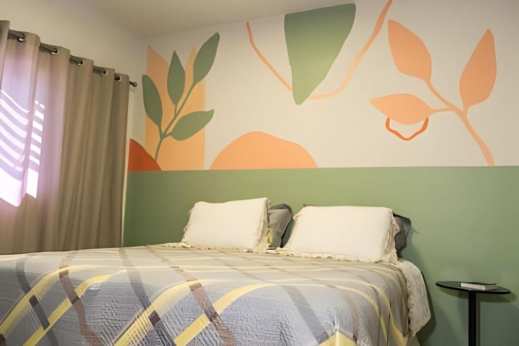 a bedroom with a bed with two pillows on it at Seu Refúgio em Cuiabá in Cuiabá