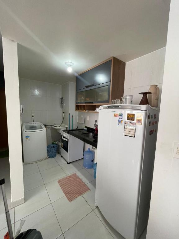 a kitchen with a white refrigerator and a sink at Przibilwiez Hause in João Pessoa