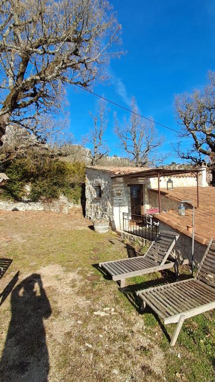 a shadow of a person standing in front of a cabin at Chambre de la roche trouee GR49 in Trigance
