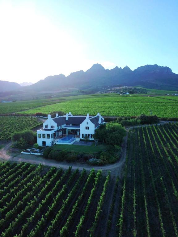 an aerial view of a house in the middle of a vineyard at Manor at Longridge in Helderberg