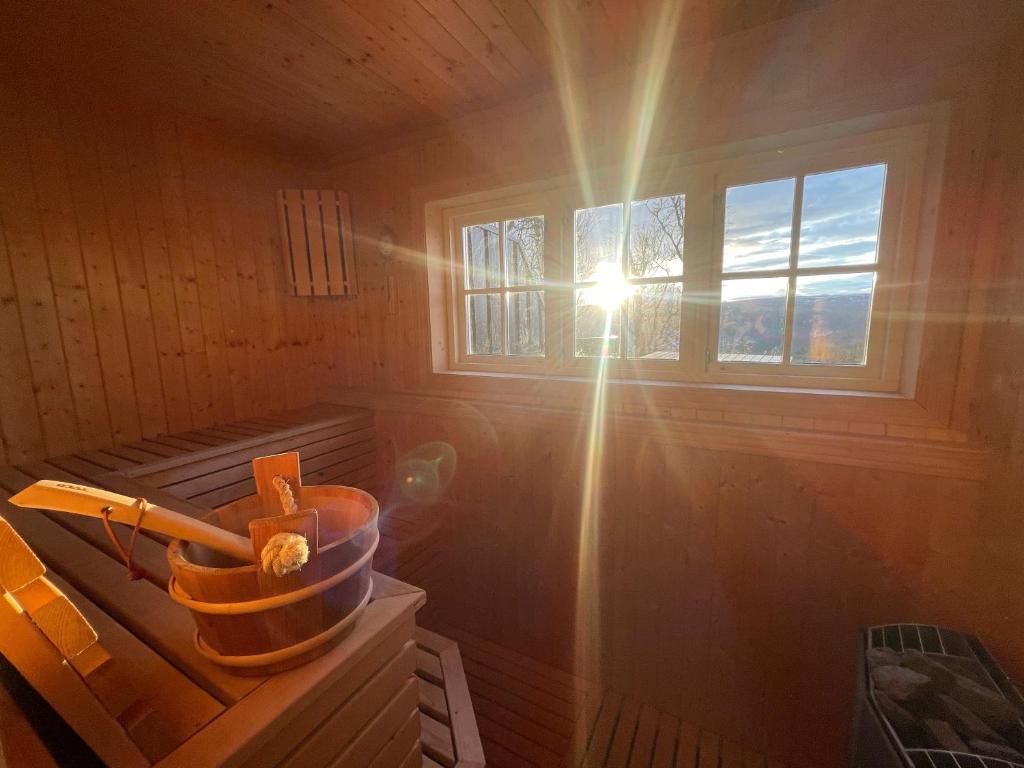 a sun shining through a window in a sauna at Koselig Gjestehus Med Badstue in Beitostøl