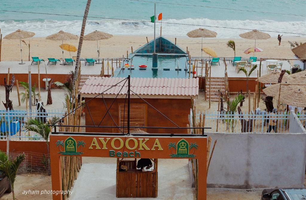 a beach with a sign that says ayocka beach at Ayooka Beach Residence Grand Bassam in Grand-Bassam