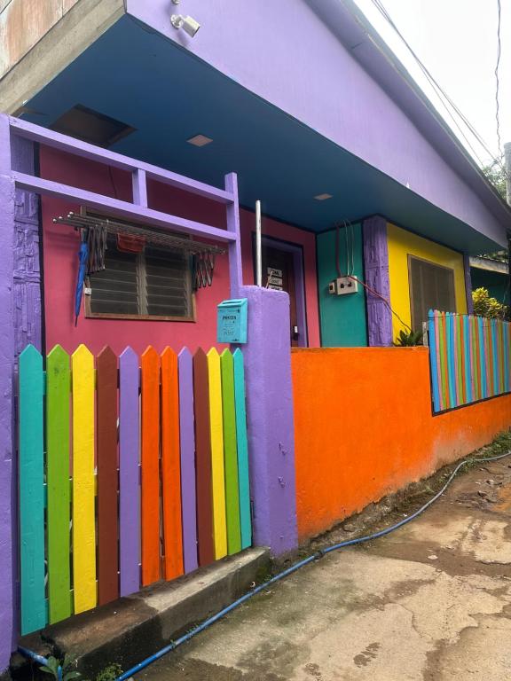 a colorful house with a fence in front of it at El Nido Homestay in El Nido