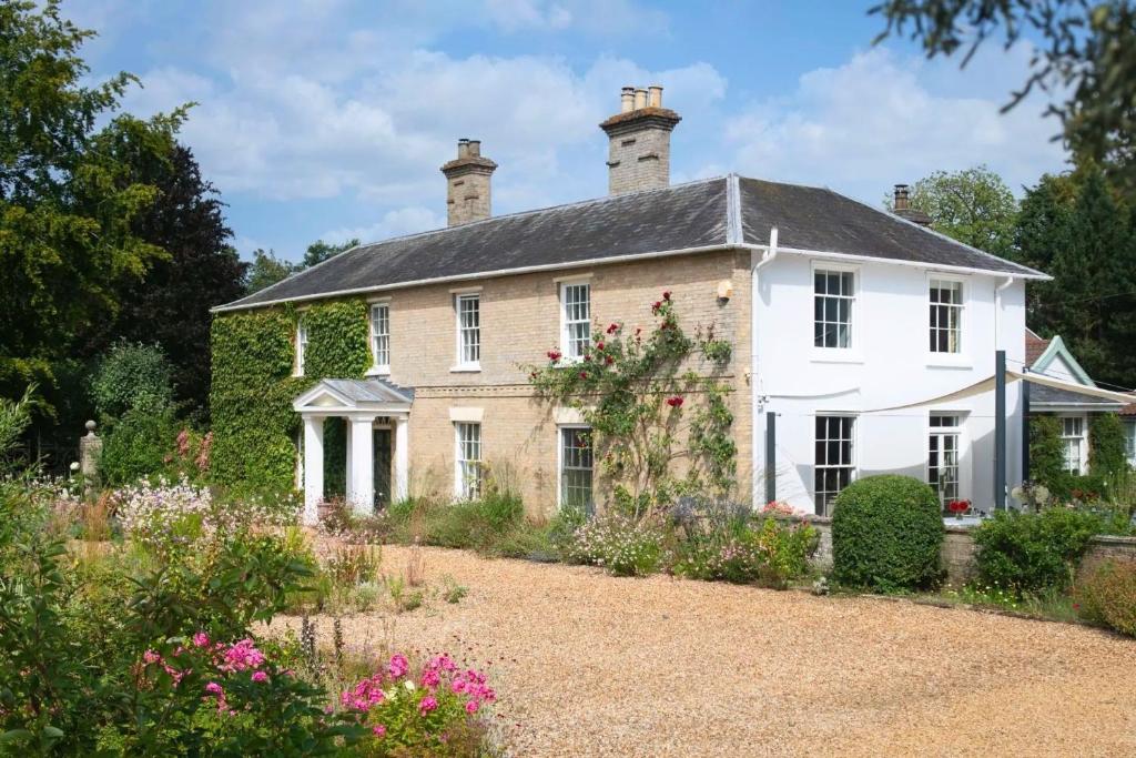 an old house with a garden in front of it at Hockham Grange in Hockham