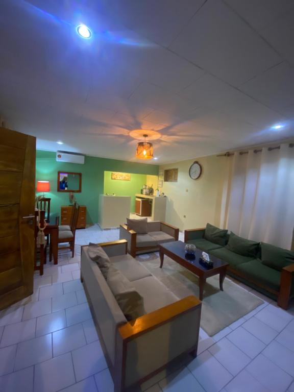a living room with a couch and a table at Nid douillet kribi in Kribi