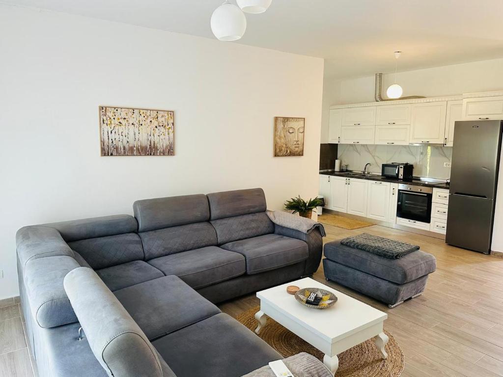 a living room with a couch and a table at Valamar Deluxe Beachfront Villa in Draç