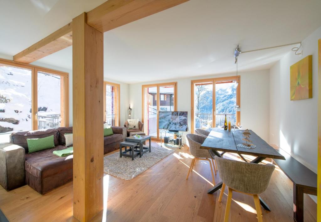 a living room with a couch and a table at Chalet Wyssbirg in Wengen