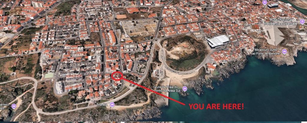a map of a city with a red arrow at SwordFish Beach House in Peniche