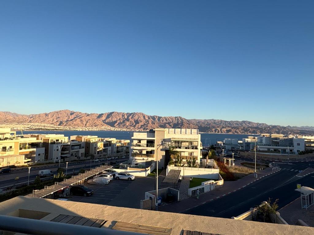 arial view of a parking lot with mountains in the background at דירה 9 in Eilat