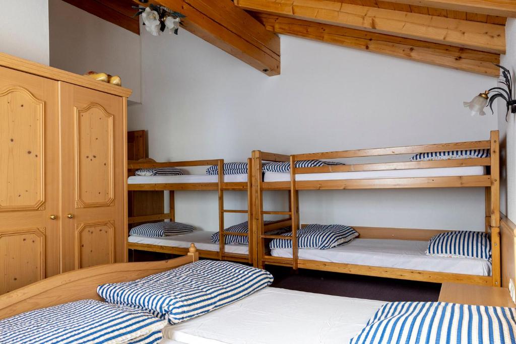 a room with three bunk beds in a room at Hecherhaus in Schwaz