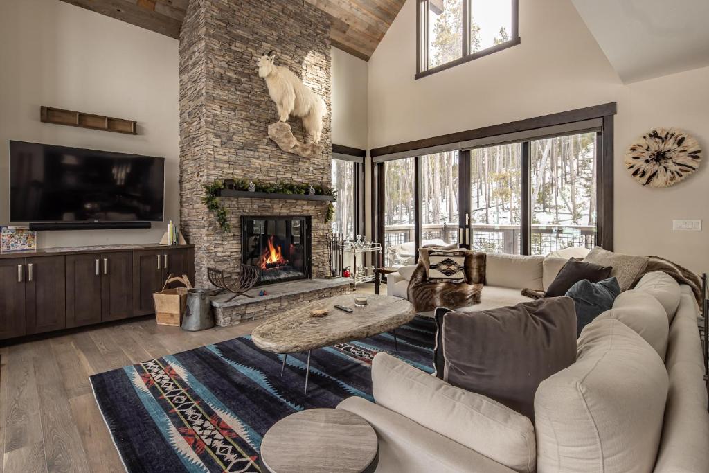 a living room with a couch and a fireplace at Spanish Peaks - Highlands Cabin 36 in Big Sky