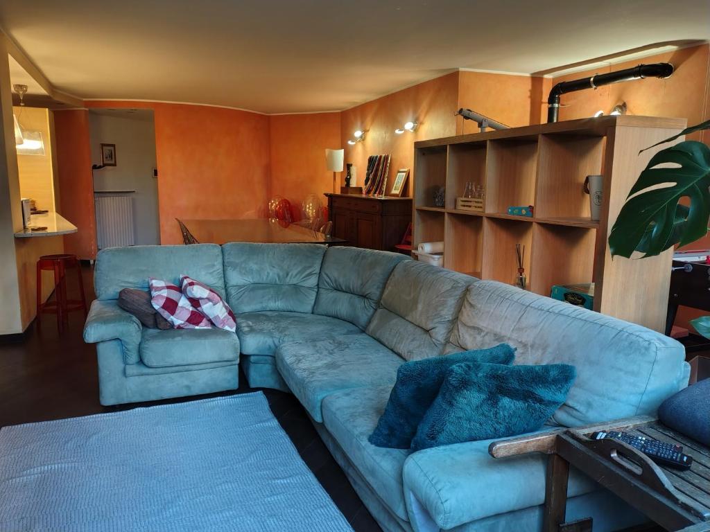 a living room with a blue couch with pillows on it at Appartamento Sleep&Fly in Grassobbio