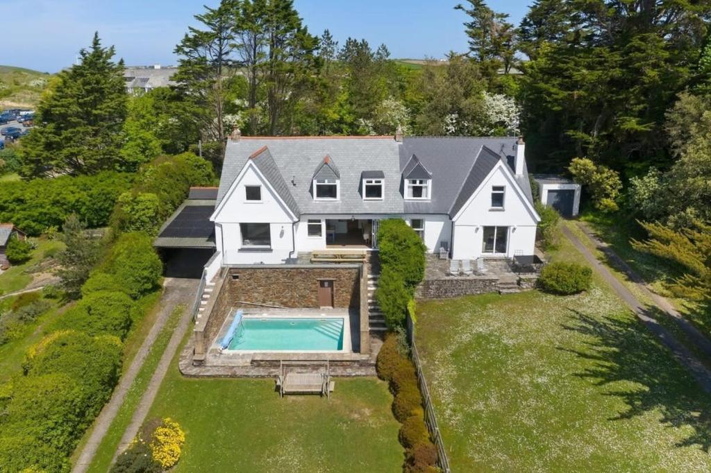 an aerial view of a house with a swimming pool at Beautiful Home with Pool Overlooking Camel Estuary in Roche
