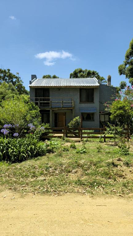 a house sitting on top of a field at La Casa de Lili in La Pedrera