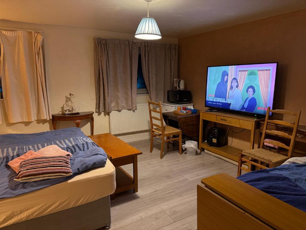 a bedroom with a bed and a tv in a room at BFamily-Jacks Court in Stalybridge