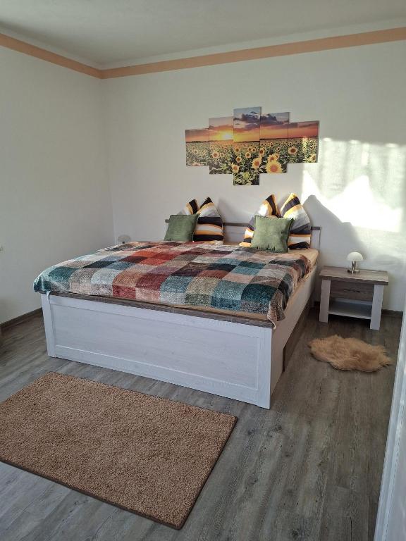 a bedroom with a large bed with a rug at FeWo LoBec 2 in Calau