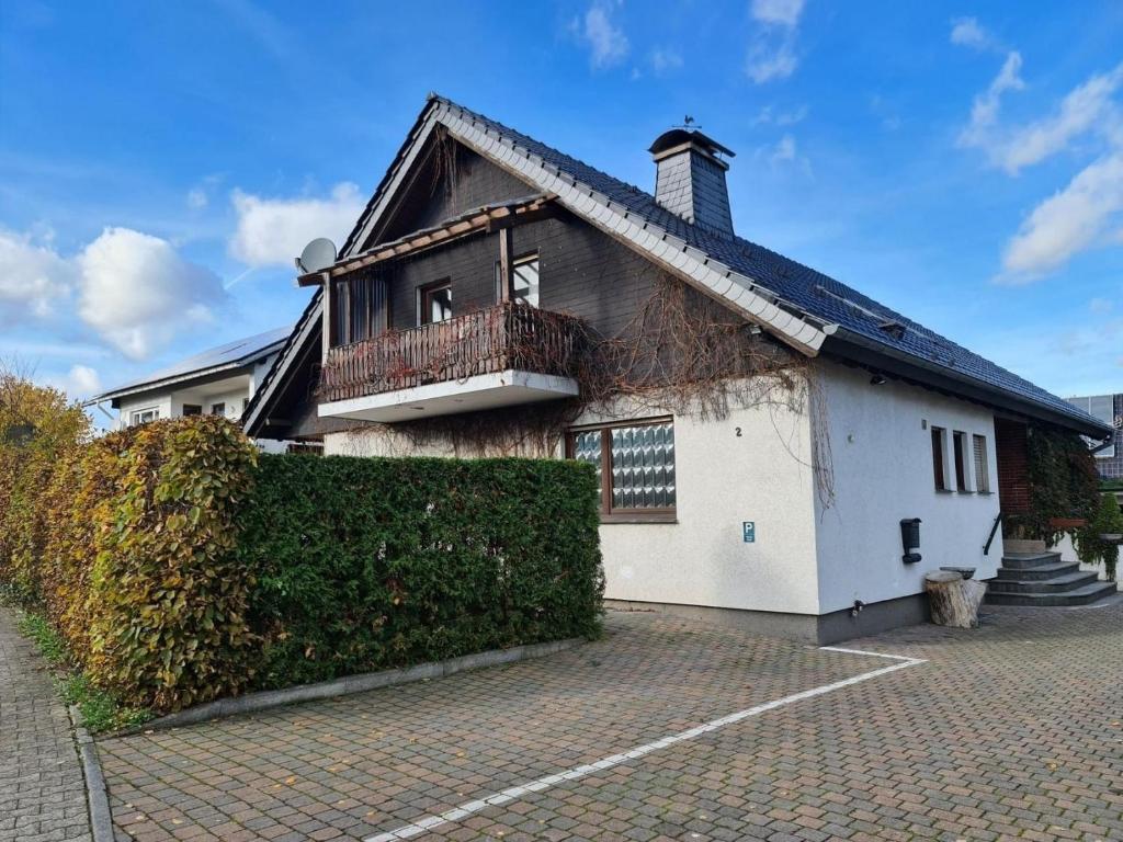 a large white house with a balcony on it at Fewo Perle Medebach in Medebach