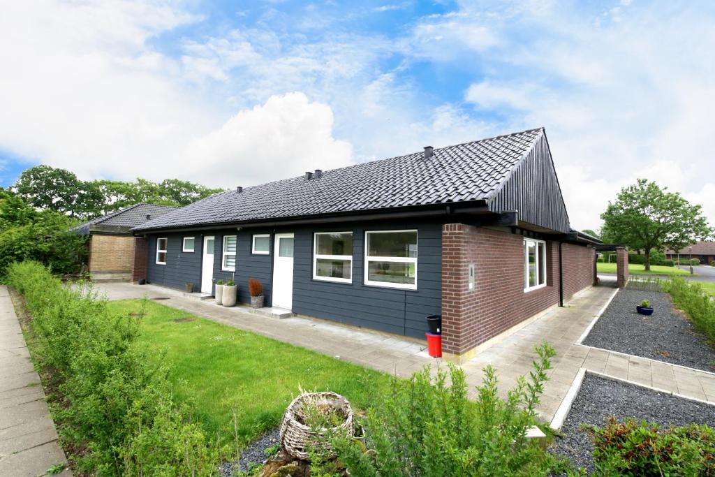 a detached house with a black roof at Granlunden id089 in Esbjerg