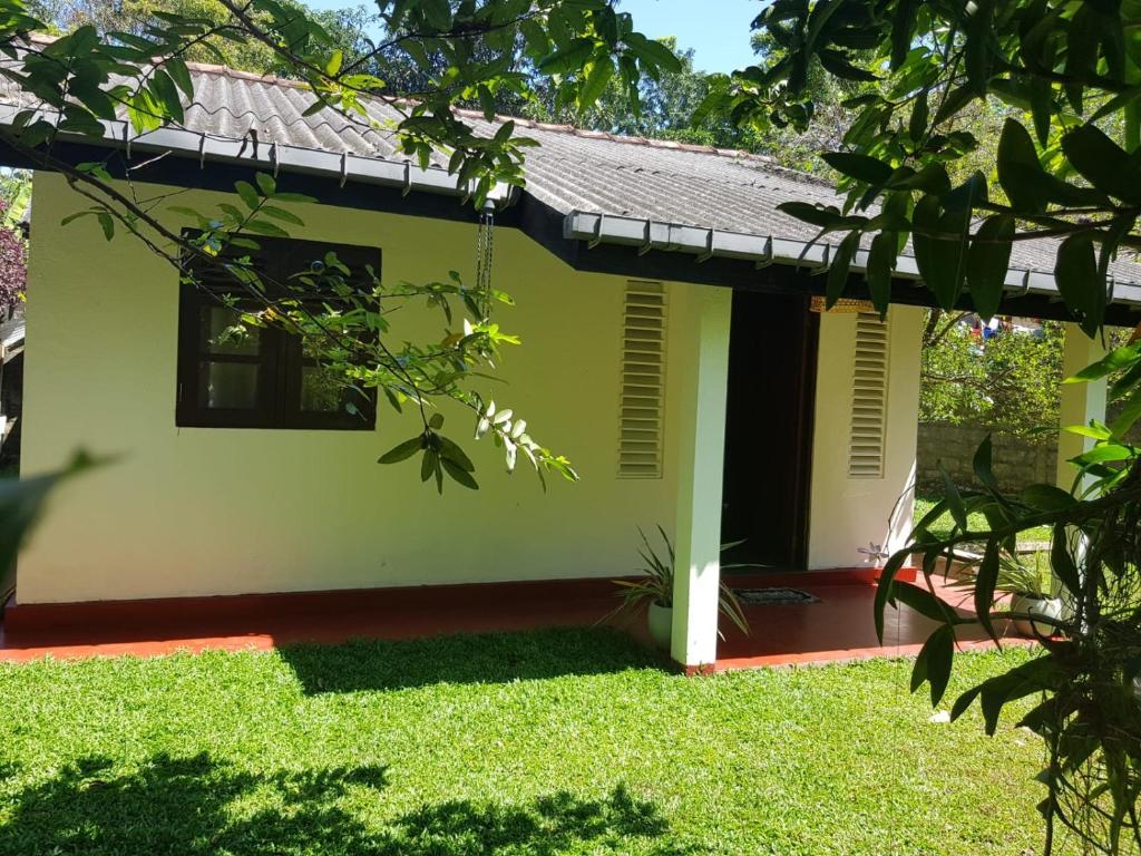 a small house with a green at Villa Golden Drift in Ahangama