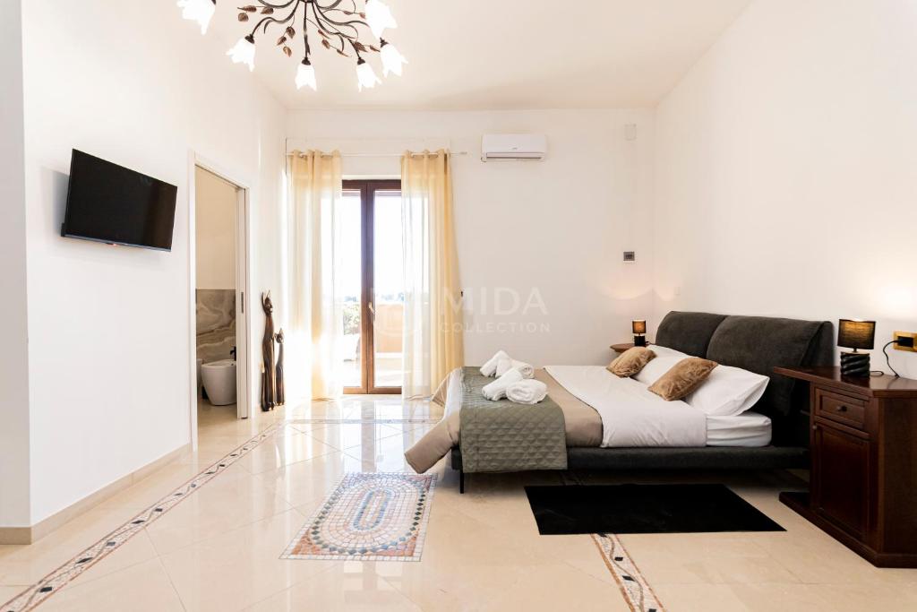 a living room with a bed and a couch at Dimora Due Mari in Salice Salentino