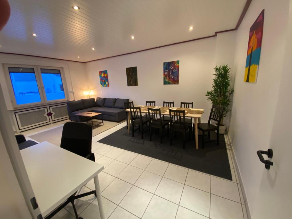 a living room with a couch and a table and chairs at Kaiserviertel Gastromeile, City, Messe & Stadionnah in Dortmund