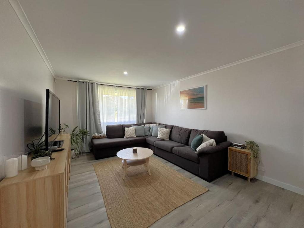 a living room with a couch and a table at Southern Comfort in Esperance in Esperance