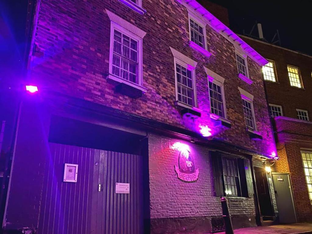 a brick building with purple lights on it at Greyfriars Lodge Canterbury in Canterbury