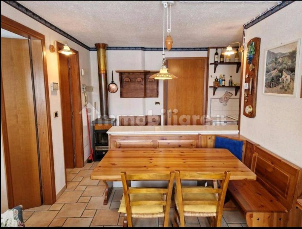 a dining room with a wooden table and chairs at Dolce Vista in Passo del Tonale