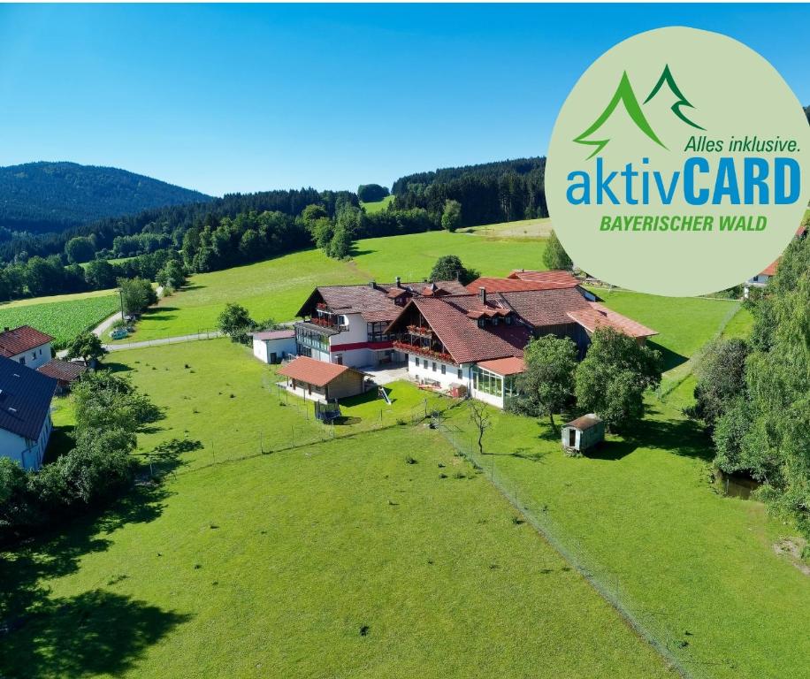 an image of an estate in a green field at Hotel Hirschenstein in Achslach