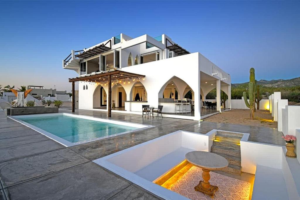 a house with a swimming pool in front of it at The Moroccan Palace Entire Villa in El Sargento