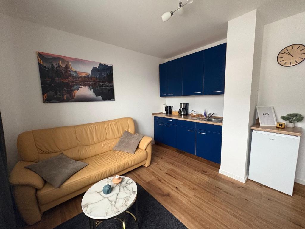 a living room with a couch and a table at Klytti‘s Pension in Sendenhorst